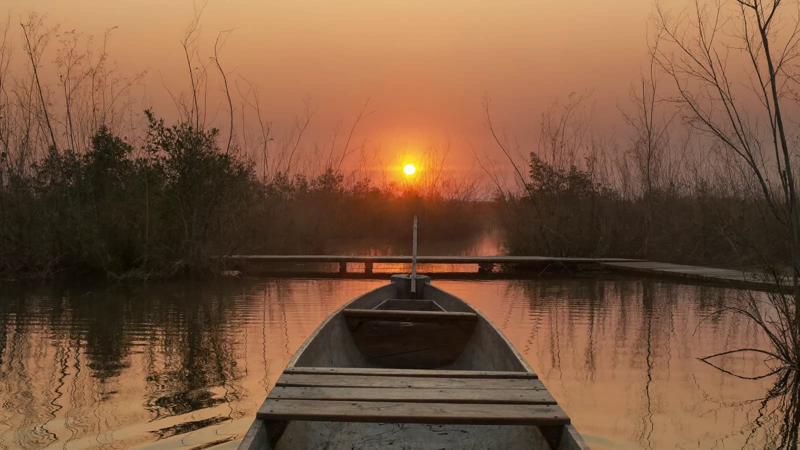 Canoa tradizionale al tramonto nella laguna di mangrovie di Mida Creek